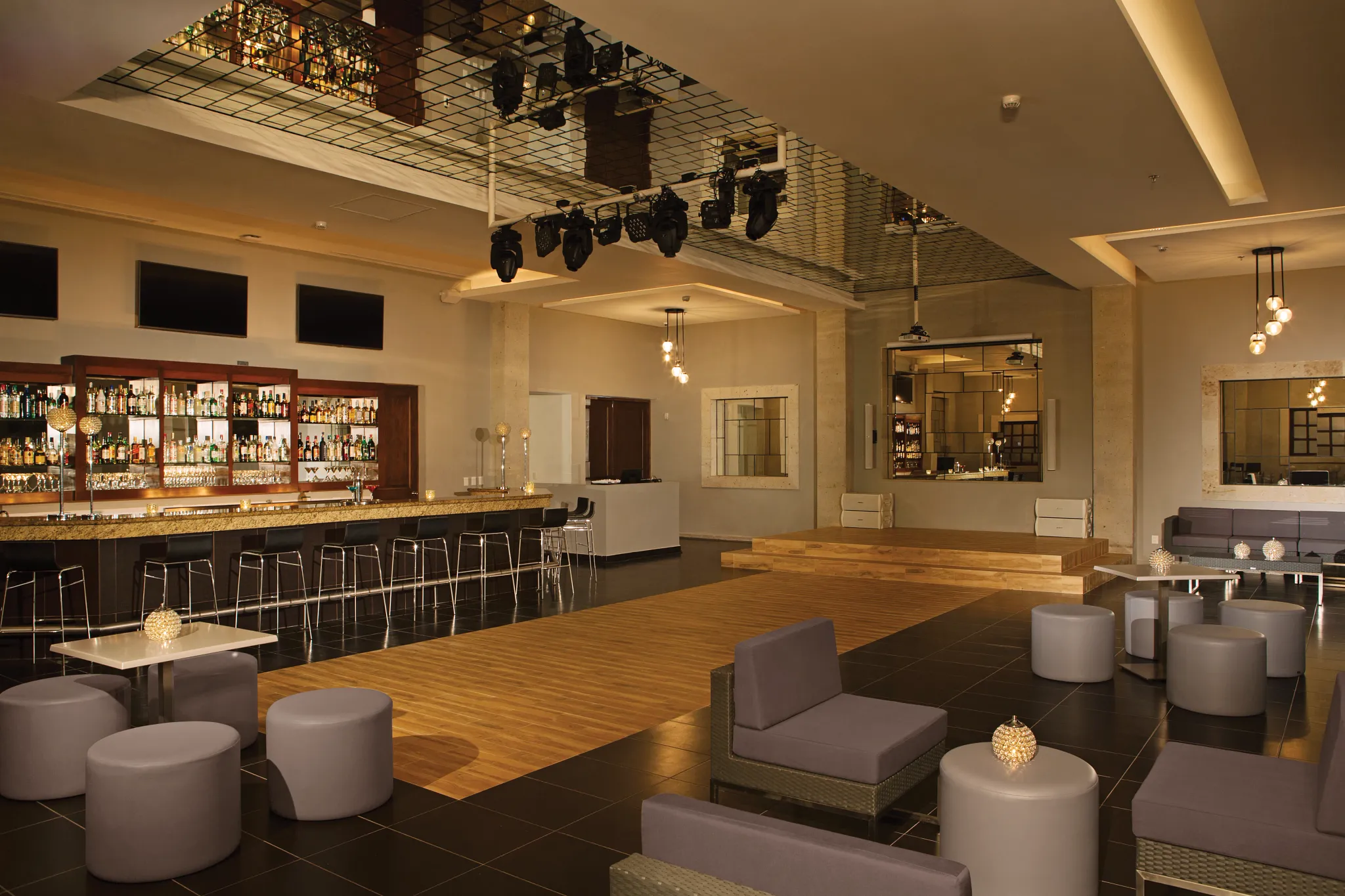 Desires Music Lounge at Dreams Los Cabos Suites Golf Resort & Spa featuring a dance floor, stylish lounge seating, and a full-service bar.