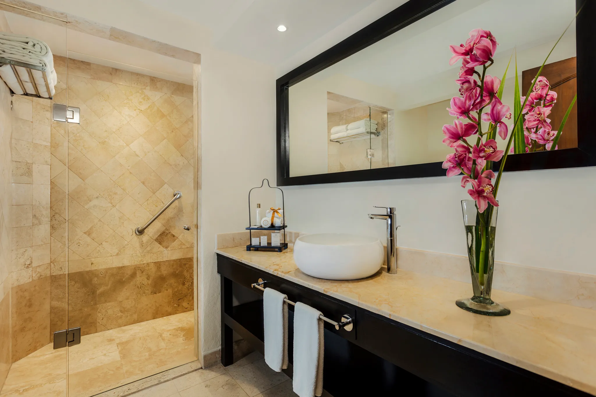 Family Junior Suite Ocean View marble bathroom with walk-in rain shower at Dreams Los Cabos Suites Golf Resort & Spa.
