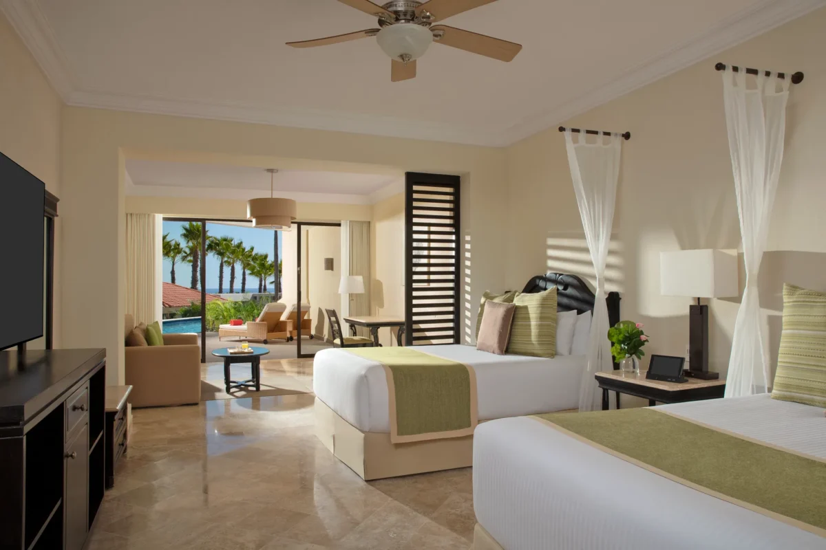 Junior Suite Pool View Swim Out with two double beds and terrace access to pool at Dreams Los Cabos Suites Golf Resort & Spa.