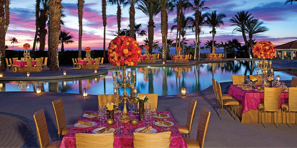 Oceana Terrace poolside wedding reception setup at sunset at Dreams Los Cabos