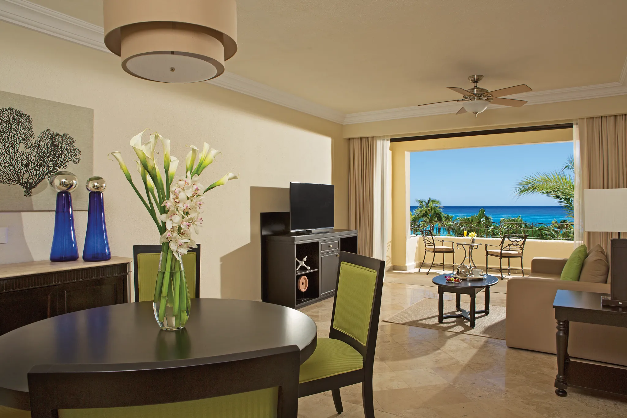 One Bedroom Suite Ocean View living and dining area with private balcony overlooking the Sea of Cortez at Dreams Los Cabos Suites Golf Resort & Spa.