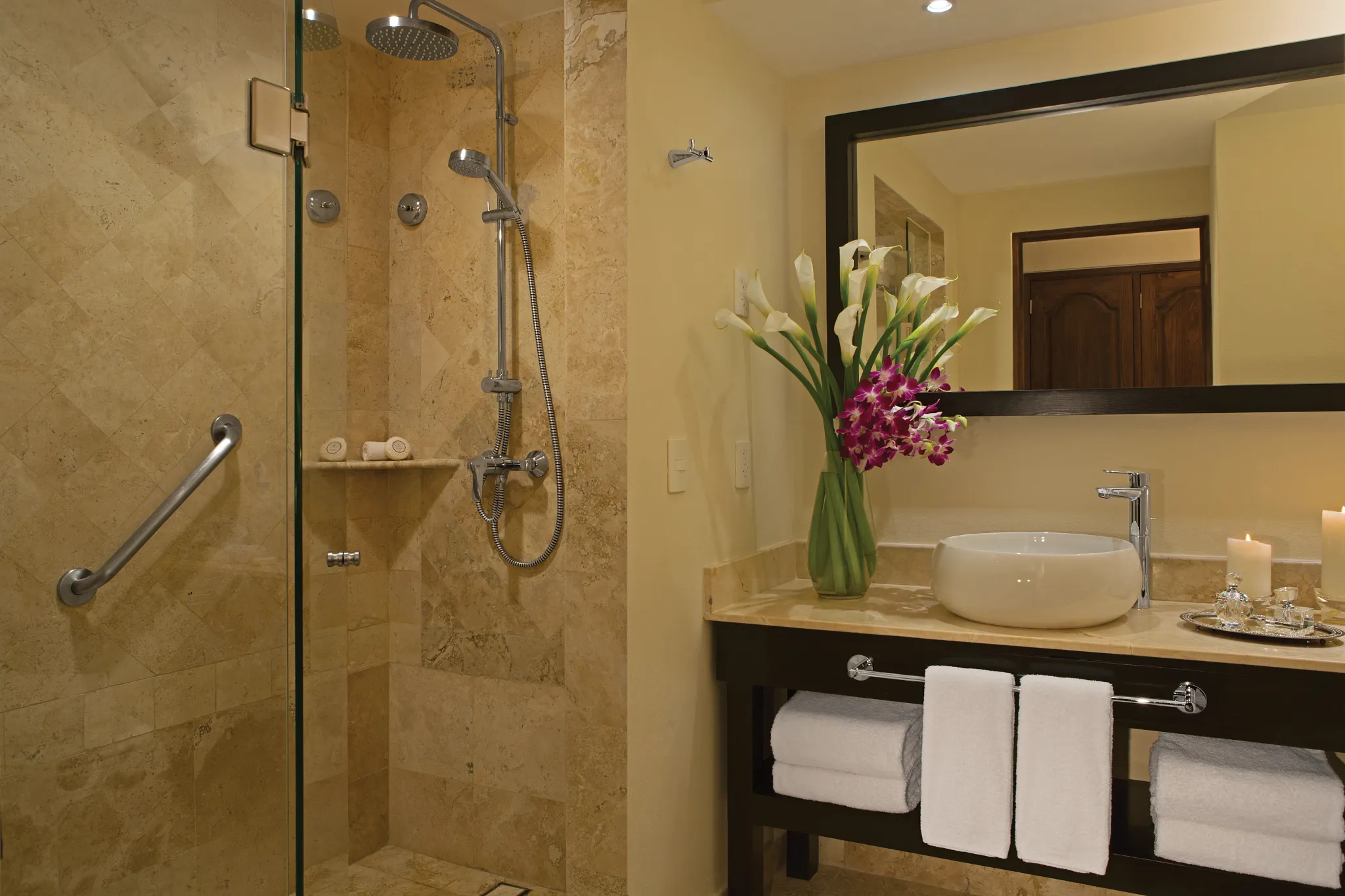 Marble bathroom with glass walk-in rain shower and vanity sink in the Preferred Club Family Master Two Bedroom Suite Oceanfront at Dreams Los Cabos.