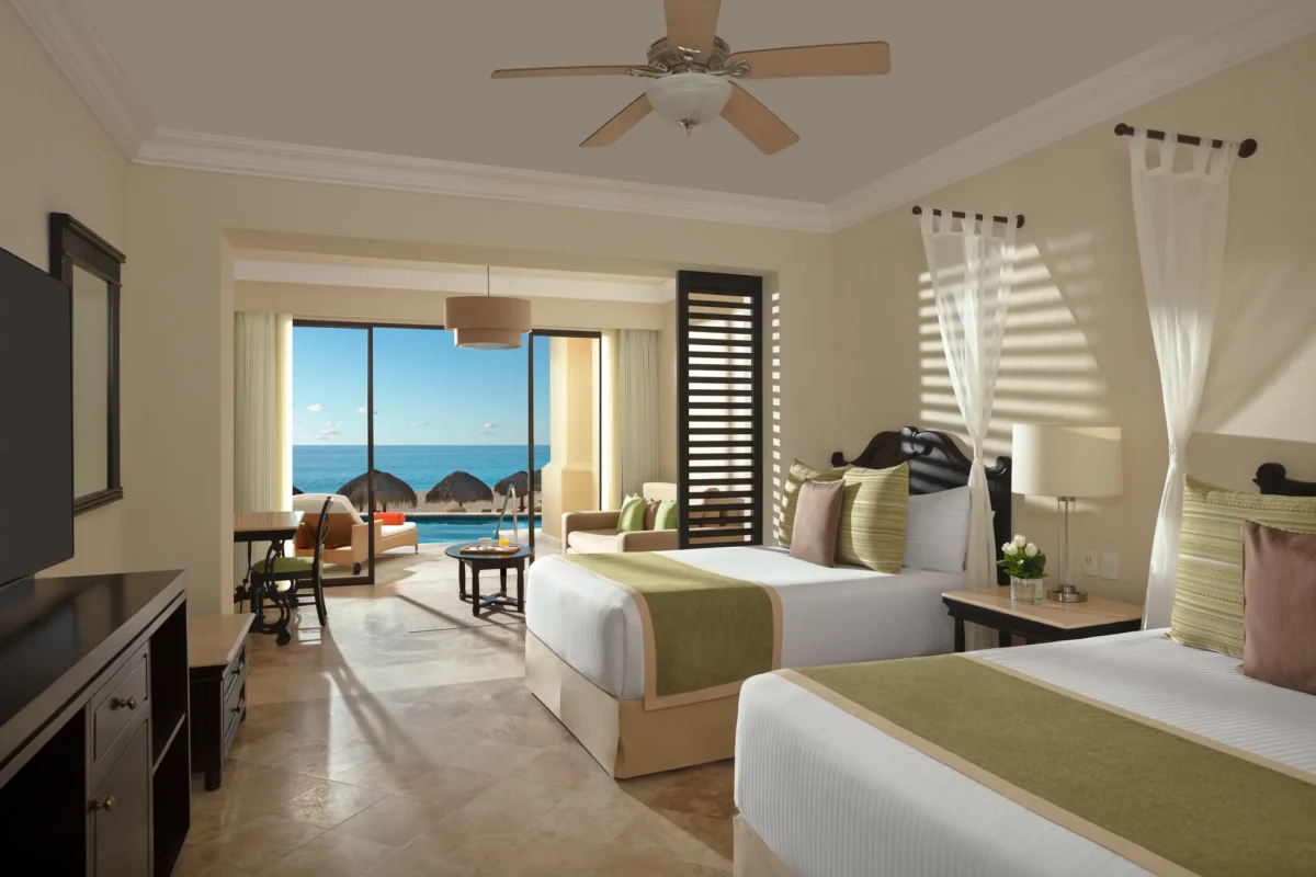 Preferred Club Junior Suite Oceanfront Swim Out with two double beds and terrace access to oceanfront pool at Dreams Los Cabos Suites Golf Resort & Spa.