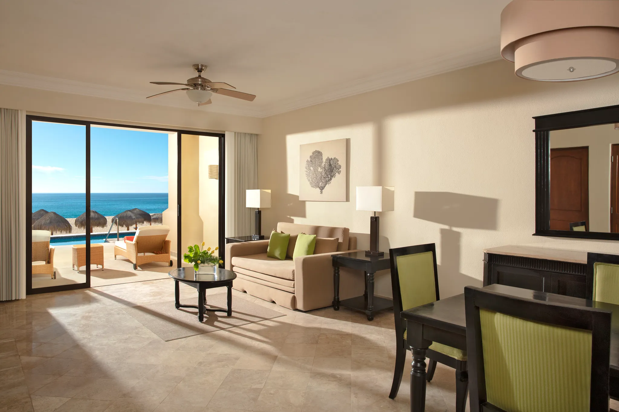 Preferred Club One Bedroom Suite Oceanfront Swim Out living area with sofa and ocean view terrace at Dreams Los Cabos.
