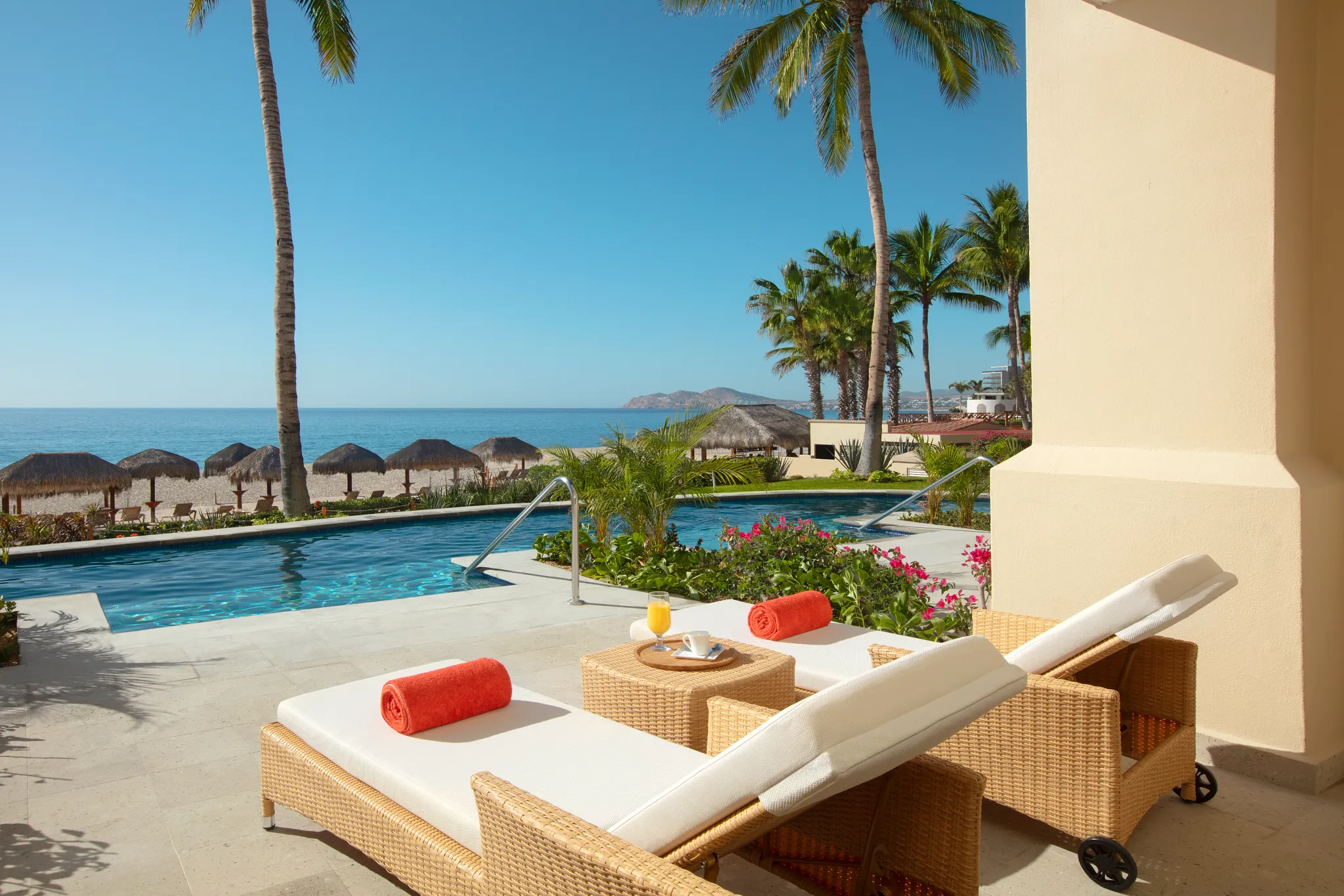 Preferred Club One Bedroom Suite Oceanfront Swim Out terrace with loungers and pool overlooking the Sea of Cortez at Dreams Los Cabos.