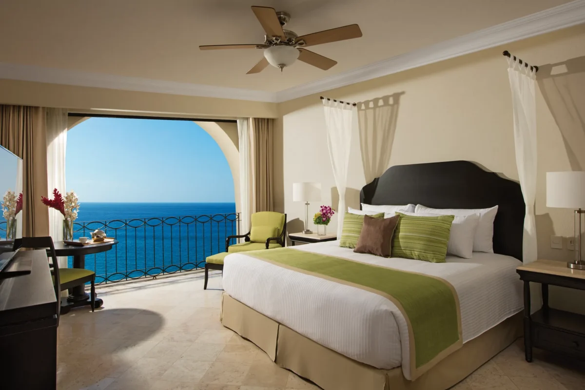 Oceanfront king bedroom with balcony view of the Sea of Cortez in the Preferred Club Presidential Suite at Dreams Los Cabos.