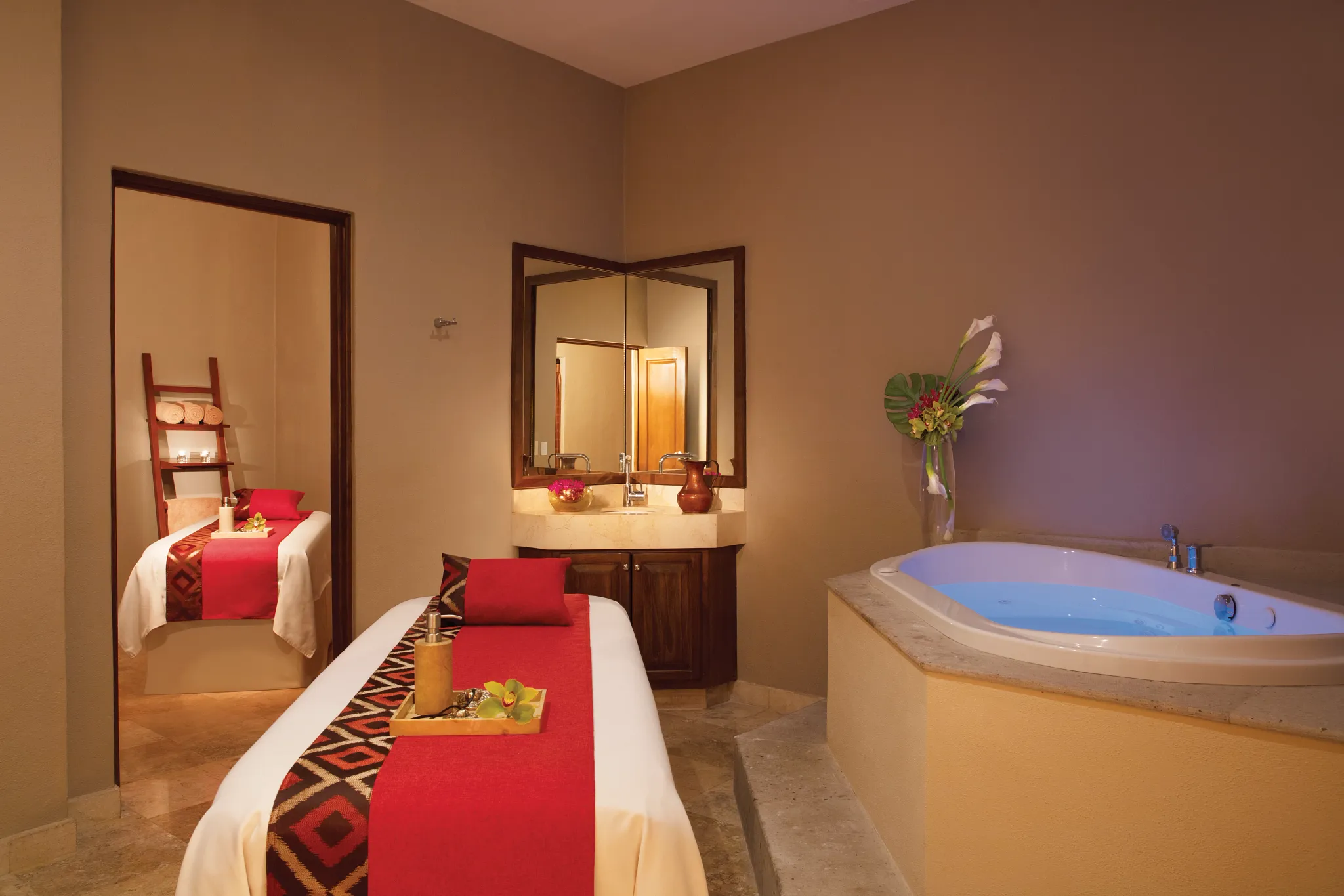 Elegant spa treatment room with massage table and whirlpool tub at Dreams Los Cabos Suites Golf Resort & Spa.